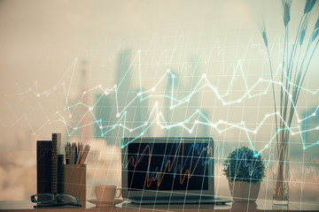 Double exposure of chart and financial info and work space with computer background. Concept of...