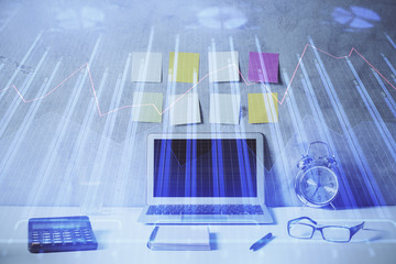 Multi exposure of chart and financial info and work space with computer background. Concept of...