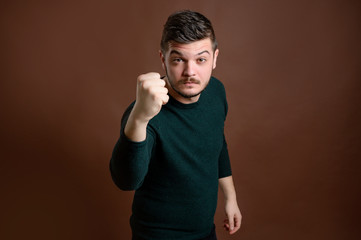 Naklejka premium Young man shows his fist