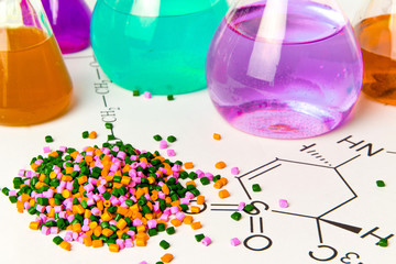 Plastic raw material in granules against the background of Chemical Laboratory and reagents....