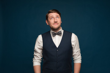 Pensive young man in formal suit