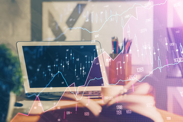 Financial graph colorful drawing and table with computer on background. Multi exposure. Concept of...