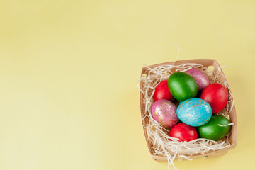 Happy Easter eggs yellow background. Golden shine decorated eggs in basket, for greeting card, promotion, poster. Copy space
