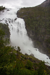Fototapeta na wymiar Stunning waterfall in Husedalen valley in Hardangervidda national park, Norway