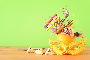 Purim celebration image (jewish carnival holiday) with traditional hamantasch cookies and deer...