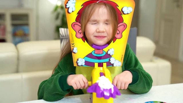 little girl plays pie in the face
