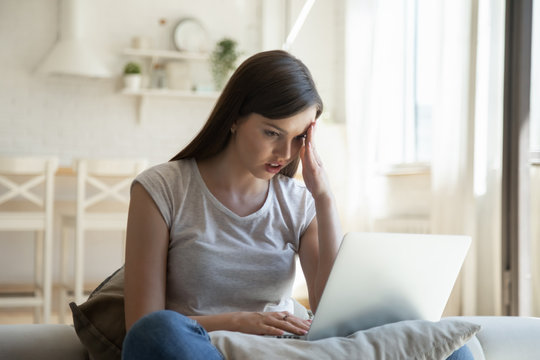 Anxious young woman having computer operational problems