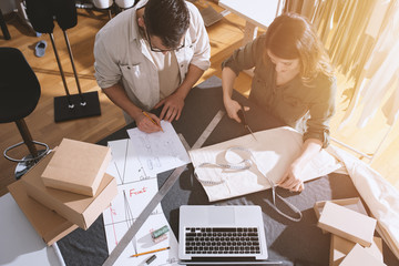 Seamstresses team ready to ship package to client with new clothes