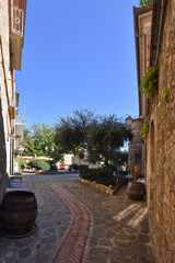 Obraz premium Acciaroli, Italy, 02/15/2020. A narrow street between the old houses of a village in southern Italy