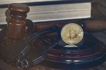 bitcoin, judge's hammer, handcuffs. Concept bitcoin ban, violation of the law.