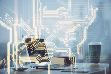 Computer on desktop in office with technology theme hologram. Multi exposure. Tech concept.