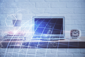 Multi exposure of table with computer and world map hologram. International data network concept.
