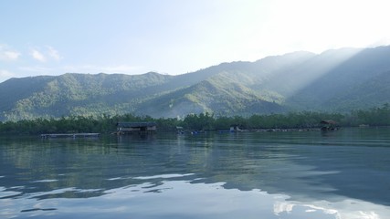 Panoramic shot of a fishing village reflected in the waters early in the morning.