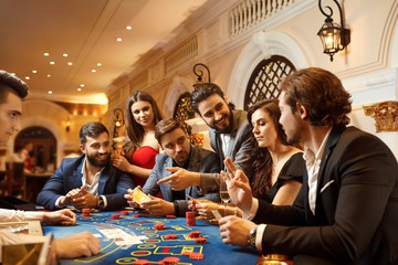 A group of people playing gambling in a casino