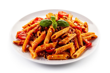 Penne with meat, tomato sauce and vegetables on white background