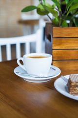 Coffee mug on wooden table. Close-up.
