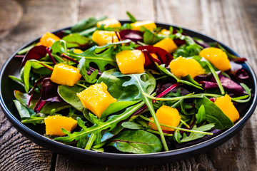 Mango with vegetables on wooden table
