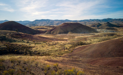 Breathtaking colorful John Day Fossil Beds Painted Hills with red green black orange and yellow stripes in a semi desert landscape in Oregon