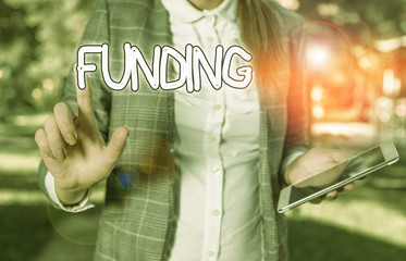 Conceptual hand writing showing Funding. Concept meaning money provided by an organization or...