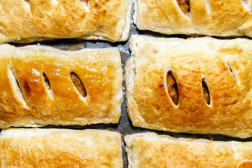 Bake in the oven puff pastry with Apple filing close-up. Cooking homemade cakes top view