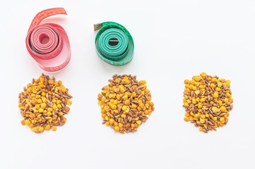lentils and spelt with a centimeter ribbon on a white background. The concept of losing weight and...