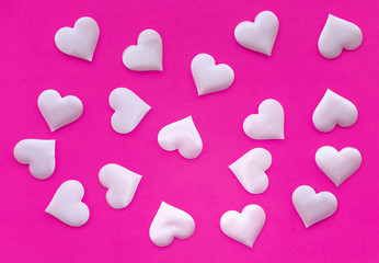 Texture. Satin pink hearts on a pink background. The view from the top. The concept of relationships and love.