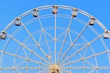 Ferris wheel against the blue sky in summer