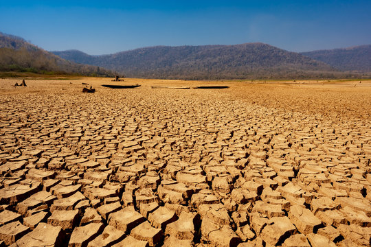 Cracked Earth From Arid Drought Weather In Dam Or River, Hot Summer Nature And Warming Climate Environment