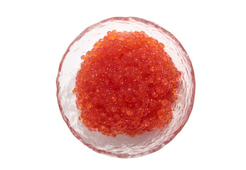 Red caviar lies in a glass bowl. Isolated object on a white background
