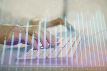 Forex graph with businessman working on computer in office on background. Concept of hardworking....