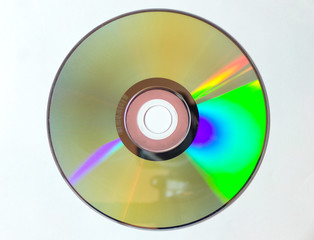 DVD CD is isolated on a white background. Iridescent disk in close-up.