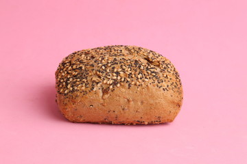 delicious bread rolls on colored background