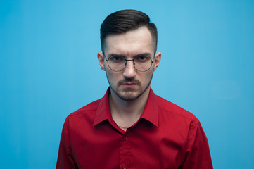 Young man in glasses and a burgundy shirt