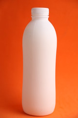 liquid yogurt bottle in color background