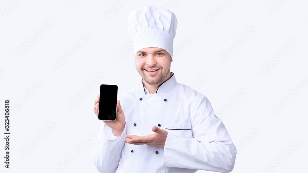 Poster restaurant chef showing cellphone with empty screen on white background