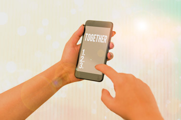 Conceptual hand writing showing Together. Concept meaning A close and harmonious relationship in...