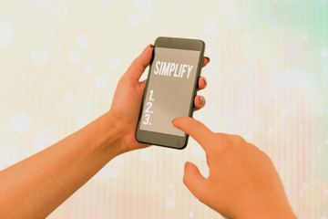 Conceptual hand writing showing Simplify. Concept meaning make something simpler or easier to do or...