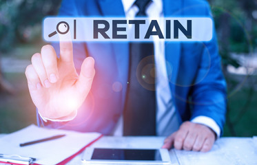 Handwriting text Retain. Conceptual photo Keep in one pay or service specifically or to keep in possession Businessman with pointing finger in front of him
