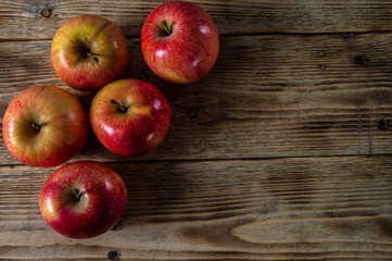 Ripe and juicy apples lie on a wooden table