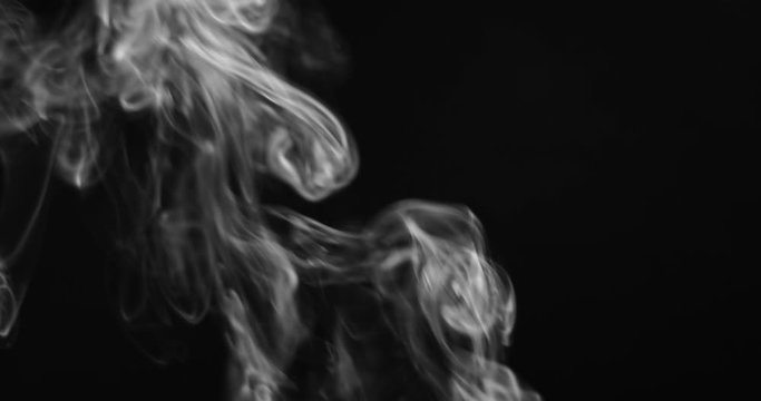 White smoke rising against dark background