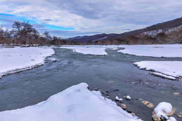 River passing through a mountain gorge in winter