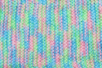 Fototapeta na wymiar Textured knitted color background. Selective focus. Soft yarn. Handmade