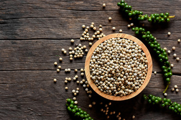 Pepper seeds in cups placed on old wooden tables.