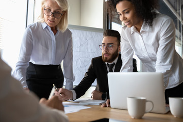 Busy multiracial office workers brainstorming at group meeting in boardroom