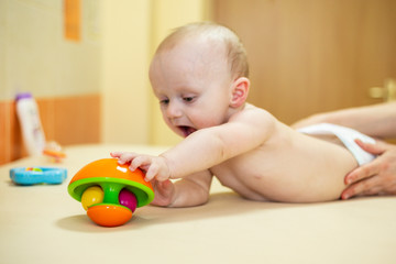 Pediatric Physical Therapy - an infant exercising on a table