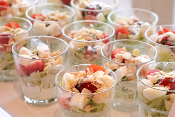 Vegetable appetizers in glasses on a banquet table. Treats for guests at  celebration.