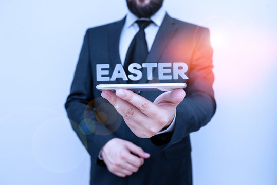 Handwriting text writing Easter. Conceptual photo the most important and oldest festival of the Christian Church Male human wear formal work suit hold smart hi tech smartphone use one hand