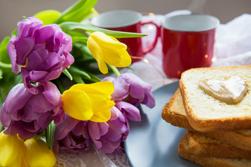Cozy weekend morning with breakfast in bed. Coffee, fig toast and flowers.