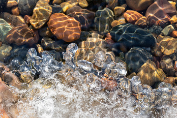 Spring background: curly edge of melting ice, clear river water