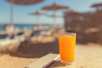 Mango juice in a glass on the beach